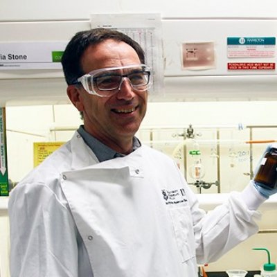 Associate Professor Mark Blaskovich holds a sample in the lab.